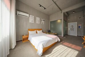 A modern hotel room with a large bed, bedside tables, an air conditioning unit, and a glass door leading to another room. - Yushan MJ Cultural Creative Theme (Huanggang)
