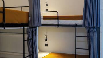 A bunk bed room with a single bed on the top bunk and a single bed on the bottom bunk.