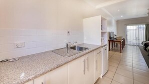 Deluxe Double Room, Patio, Courtyard View | Private kitchen | Fridge, microwave, oven, stovetop - Emerald Gardens Motel and Apartments (QLD)