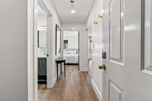 A hallway with a bed, a desk, and a wardrobe. - White Cap A-406 Ski in Ski Out Condo (Newry)