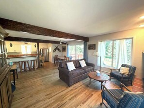 A spacious living area with a large sofa, two armchairs, a coffee table, and a dining area with a table and chairs. - Vintage Ski Haus Near Mt CB Wedding Garden (Crested Butte)