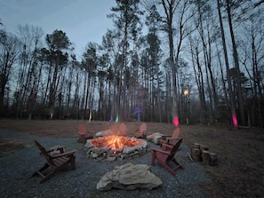 A fire pit with chairs and a stone wall in a forest setting. - Lake Anna: Hot Tub, Pool, Beach, Tennis (Mineral)