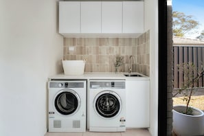 Laundry : The laundry has a front-load washer, separate dryer and bench space, making everyday washing simple during the stay.