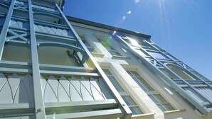 A building with a modern architectural design, featuring a prominent staircase and large windows. - Ferienwohnungen im Seepark Sellin (Sellin)