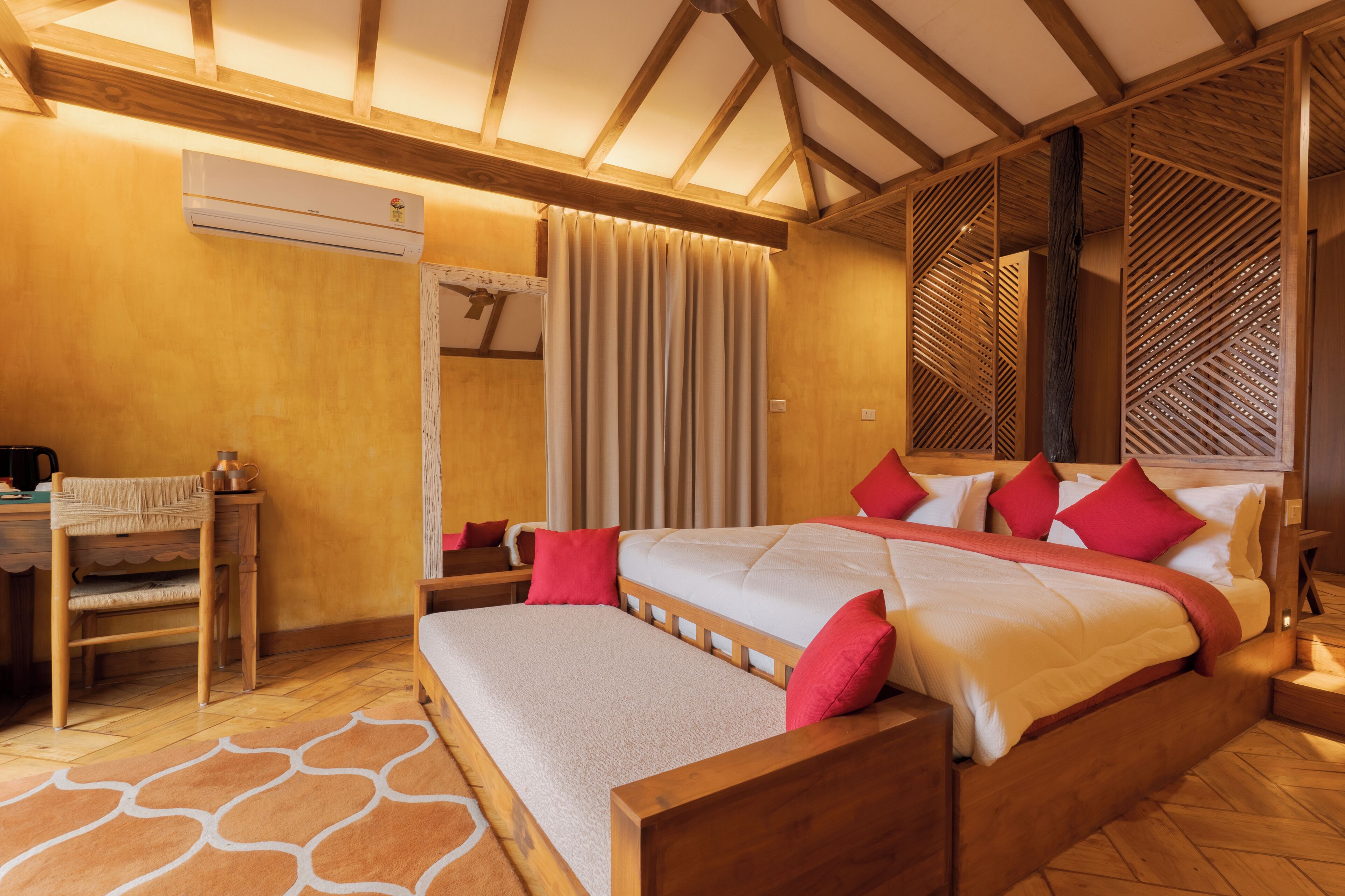 A bedroom with a wooden bed, a desk, and a chair.