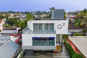 A modern building with a sign reading "G2" and a blue awning.