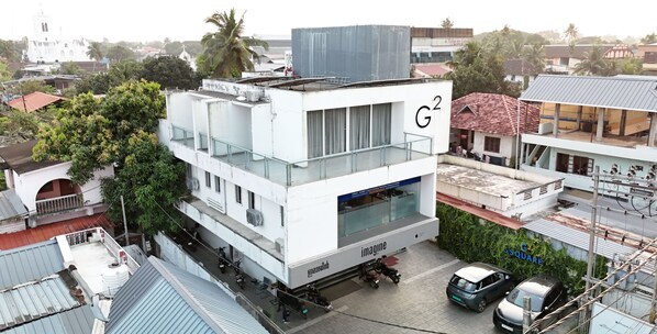 A multi-story building with a prominent 'G2' sign, a covered outdoor area, and a visible entrance.