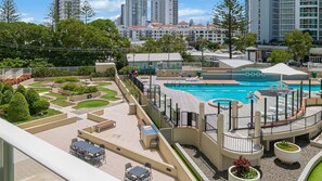 A rooftop pool area with a small garden, outdoor seating, and a view of surrounding buildings. - Twin Towns 233 - Central Coolangatta / Tweed Heads - Min. 3 Night Stays - Linen Provided (Tweed Heads)