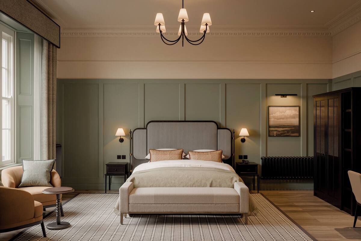 A bedroom with a large bed, two bedside tables, a chair, a chandelier, and a radiator.