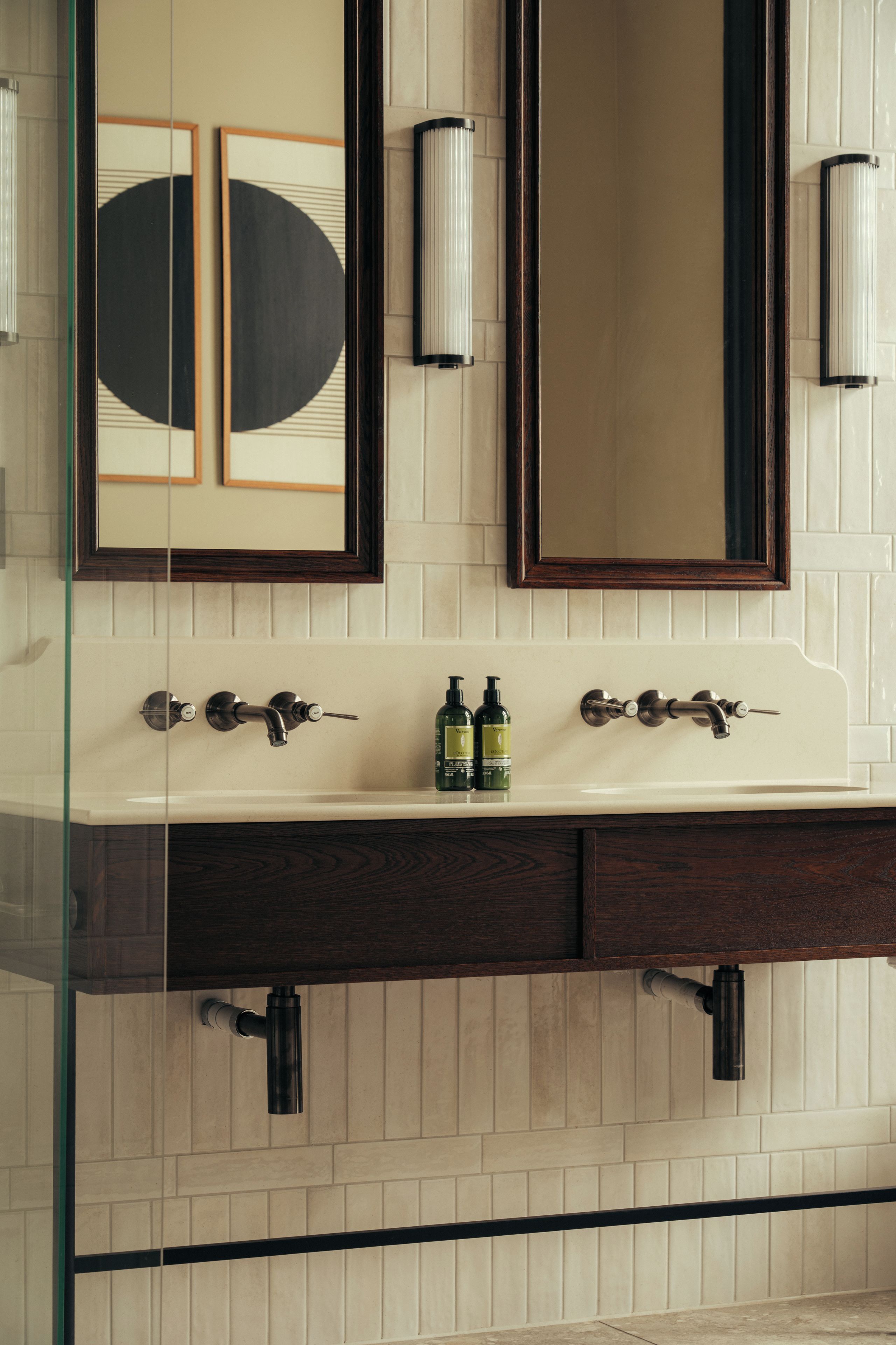 A bathroom with a double vanity, two sinks, and a large mirror above.