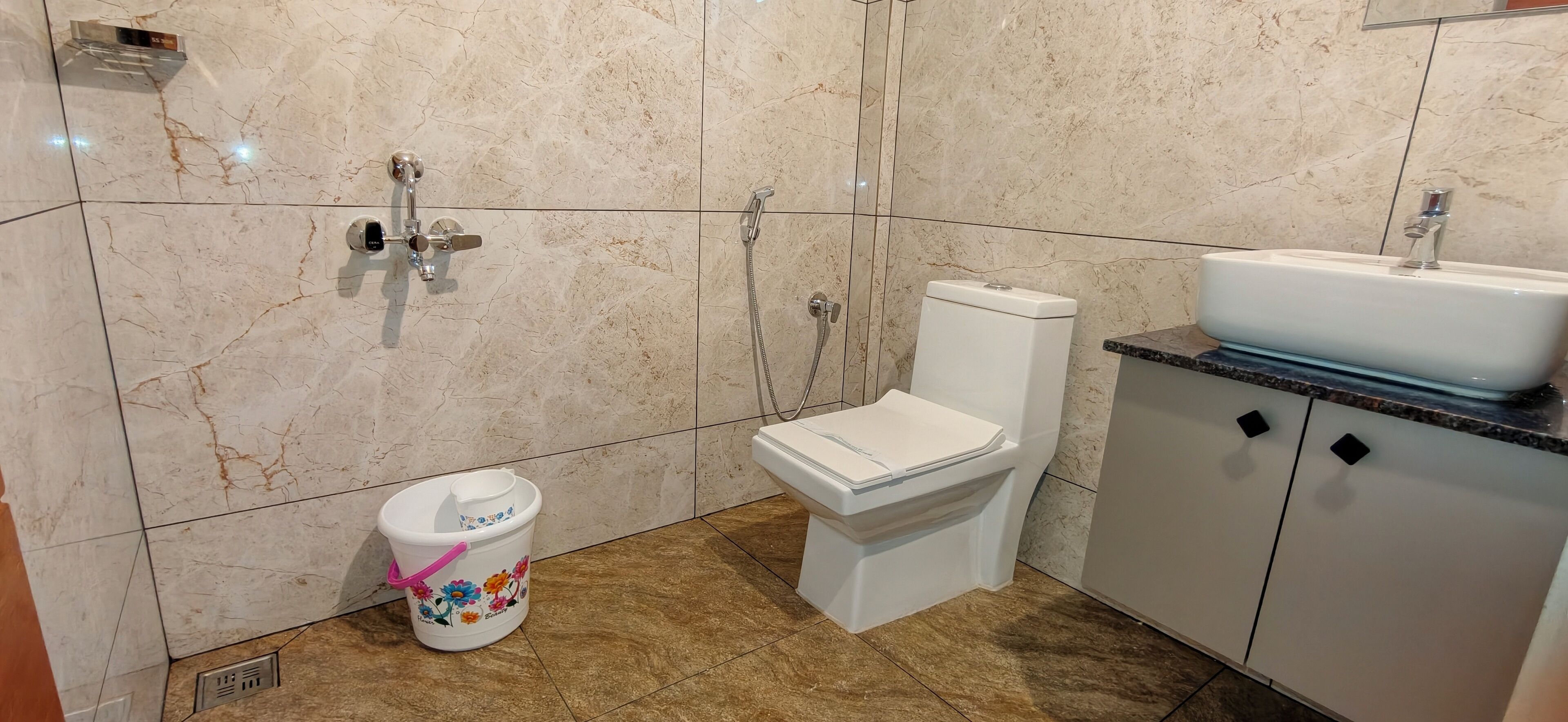 Une salle de bain équipée de toilettes, d’un bidet et d’un lavabo.
