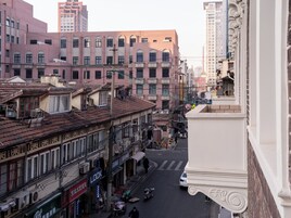 A street view with buildings, a pedestrian crossing, and a speed limit sign.