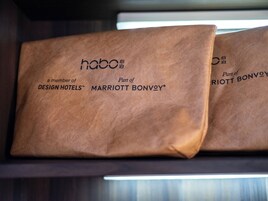 Two brown paper bags with 'habo' and 'a member of DESIGN HOTELS® MARRIOTT BONVØY' printed on them.
