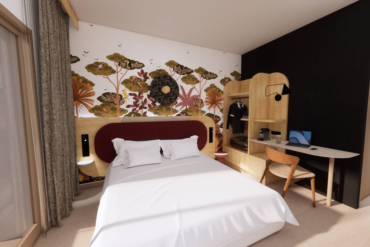 Un dormitorio con cama, escritorio, armario y una pared con un mural floral.