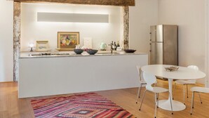 A modern kitchen with a central island, white cabinets, and a stainless steel refrigerator. - Apartment in Camaiore with 2 bedrooms sleeps 4 (Camaiore)