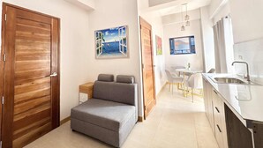 A modern kitchen with a sink and a dining area with a table and chairs. - Palette Cebu The Almonds Boutique Aparthotel Near University of Cebu (Cebu City)