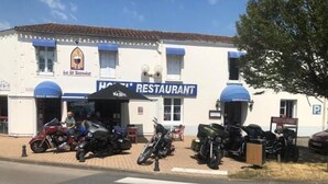 A building with a sign reading "HOTEL RESTAURANT" and a sign for "Le St Bernard". - Le Saint Benoist (Aizenay)