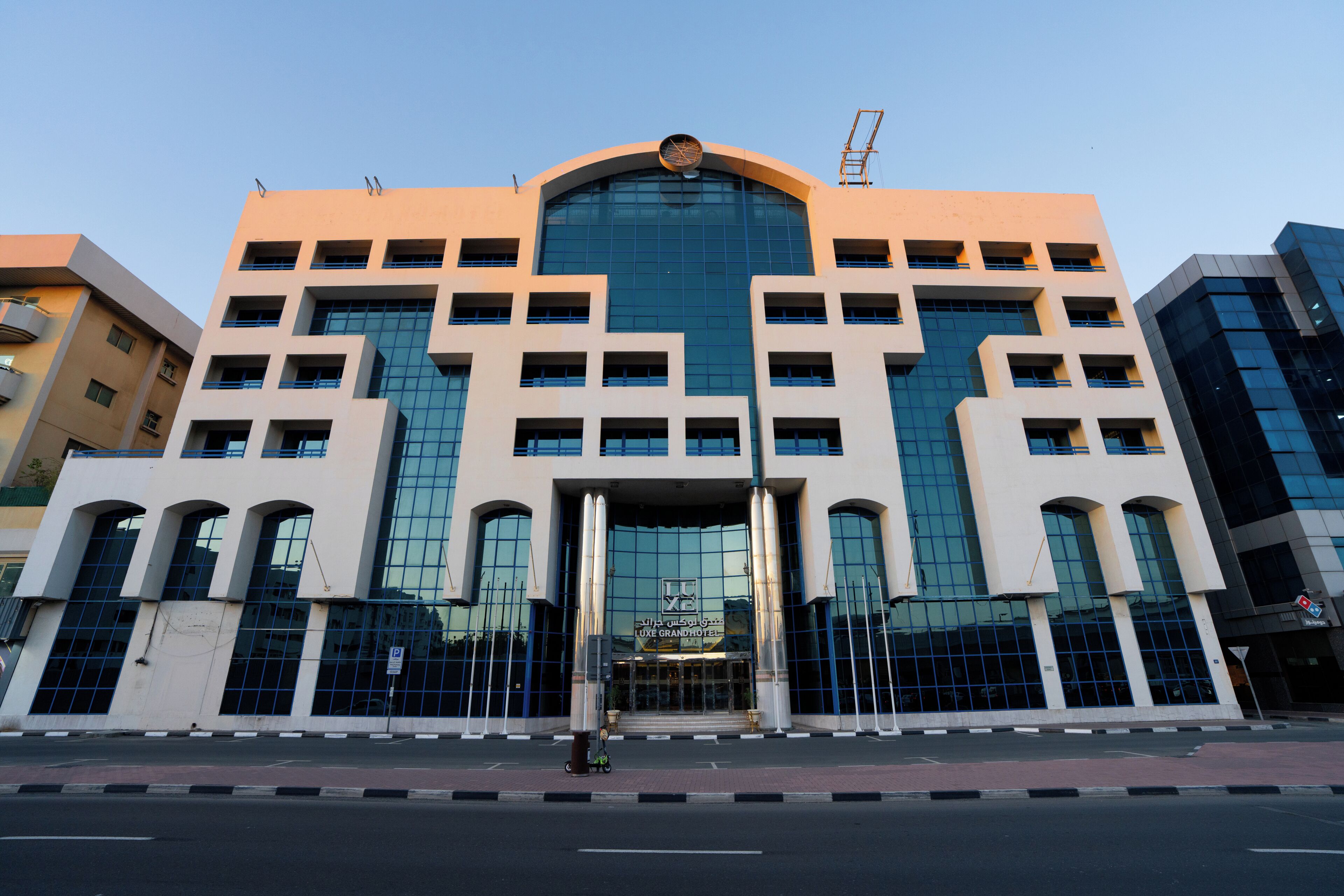A modern building with a large glass facade, multiple entry points, and a prominent entrance.