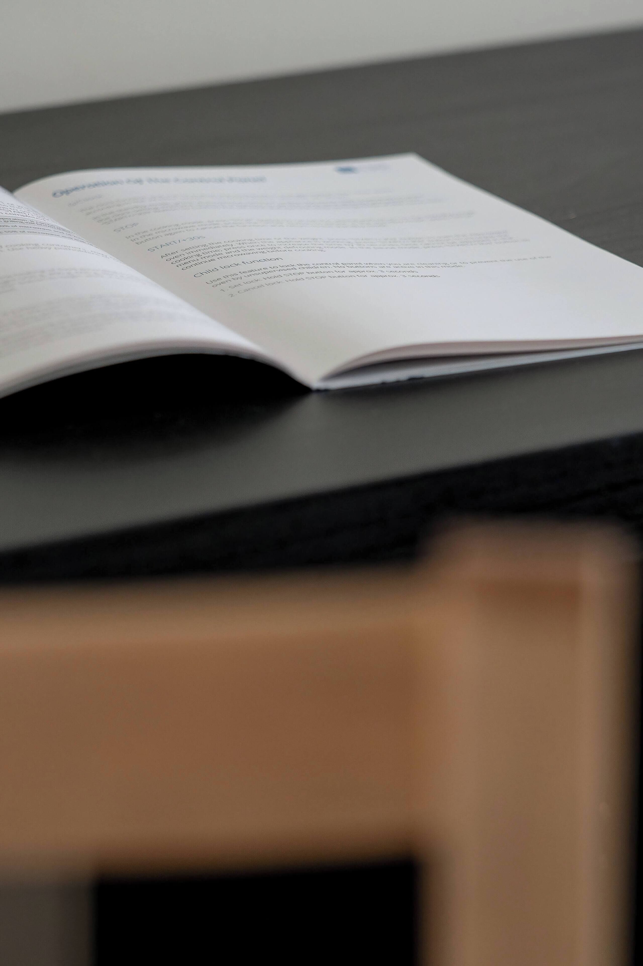 An open book on a dark surface.