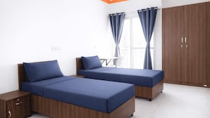 A bedroom with two beds, a wardrobe, and a window with curtains. - Truliv Luna (Bengaluru)