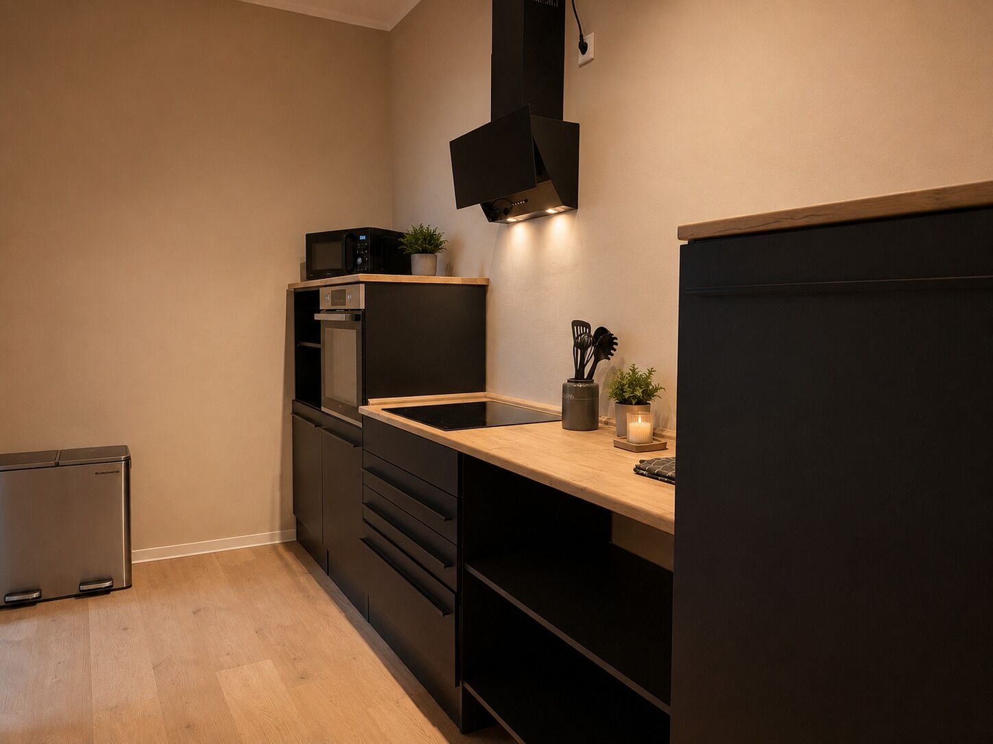 A compact kitchen with a microwave, oven, and a built-in stove.