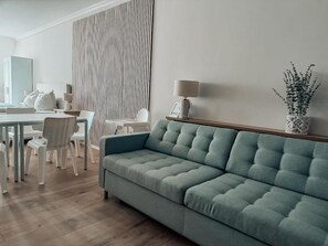 Deluxe Penthouse, City View | Living area | 50-inch Smart TV with cable channels