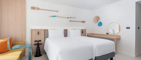 A modern hotel room with a large bed, a wooden headboard, a bedside table, a bench, and a wall-mounted mirror.