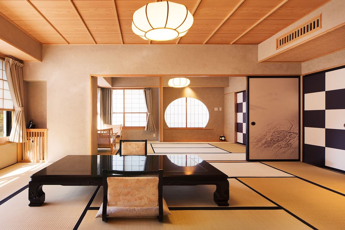 A traditional Japanese room with tatami flooring, a low table, and shoji screens.