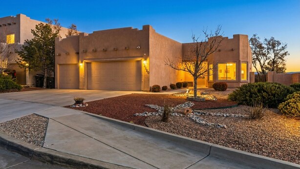 A modern house with a garage, a well-maintained garden, and a clear sky. - Indulge in this beautiful New Mexico home located in Southwest Albuquerque (Albuquerque)