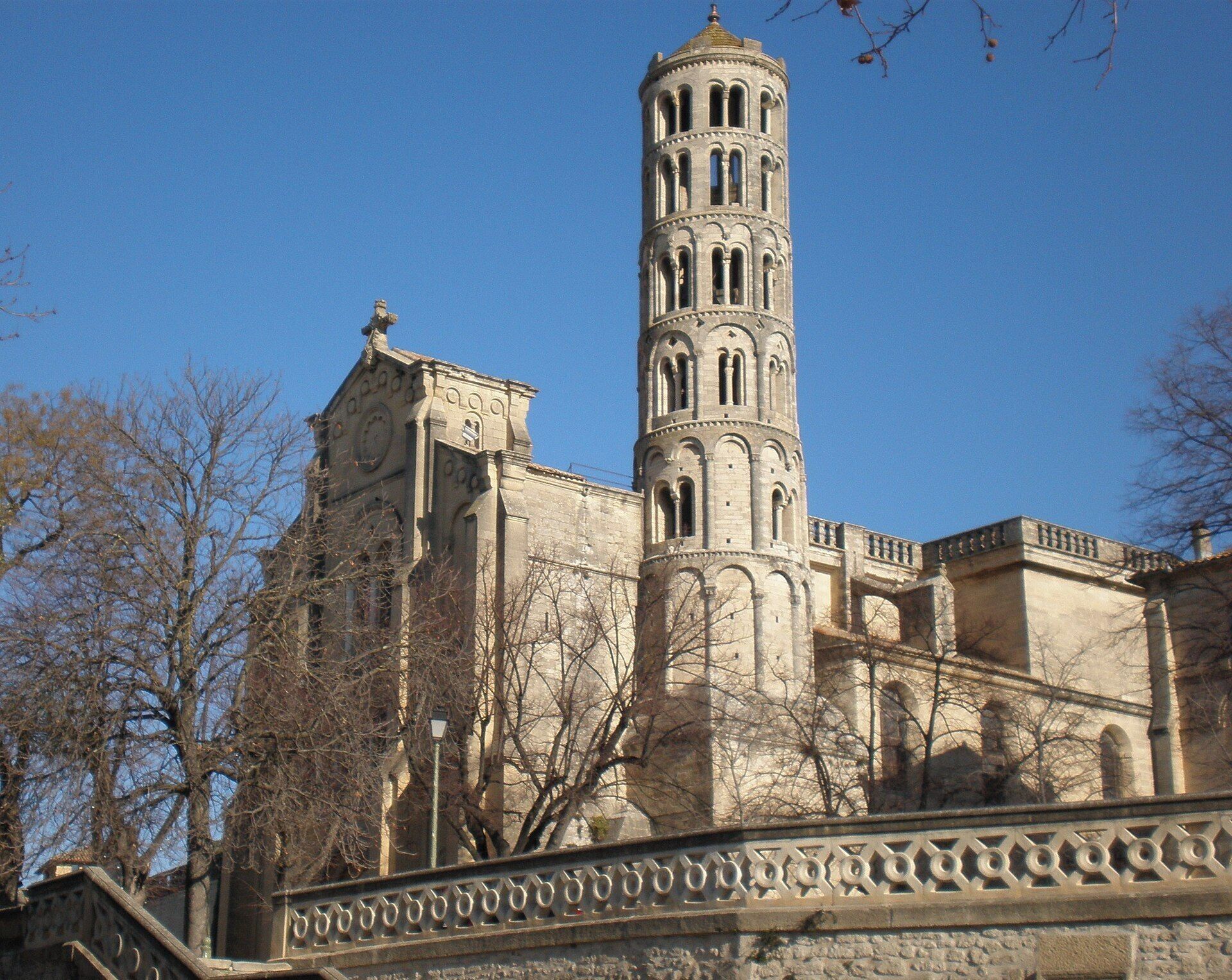 A historic building with a prominent tower featuring arched windows and a clock.