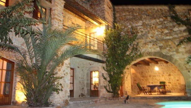 A stone building with a pool, arched doorways, and outdoor seating. - Over 1000 year old country house with pool near Uzes for 12 people, ideal for families (Foissac)