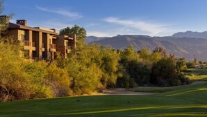 A modern building with balconies, surrounded by lush greenery and mountains in the background. - 1 Bed-room Villa with full kitchen in Palm Desert from 4/7/2026 for 5 nights (Palm Desert)