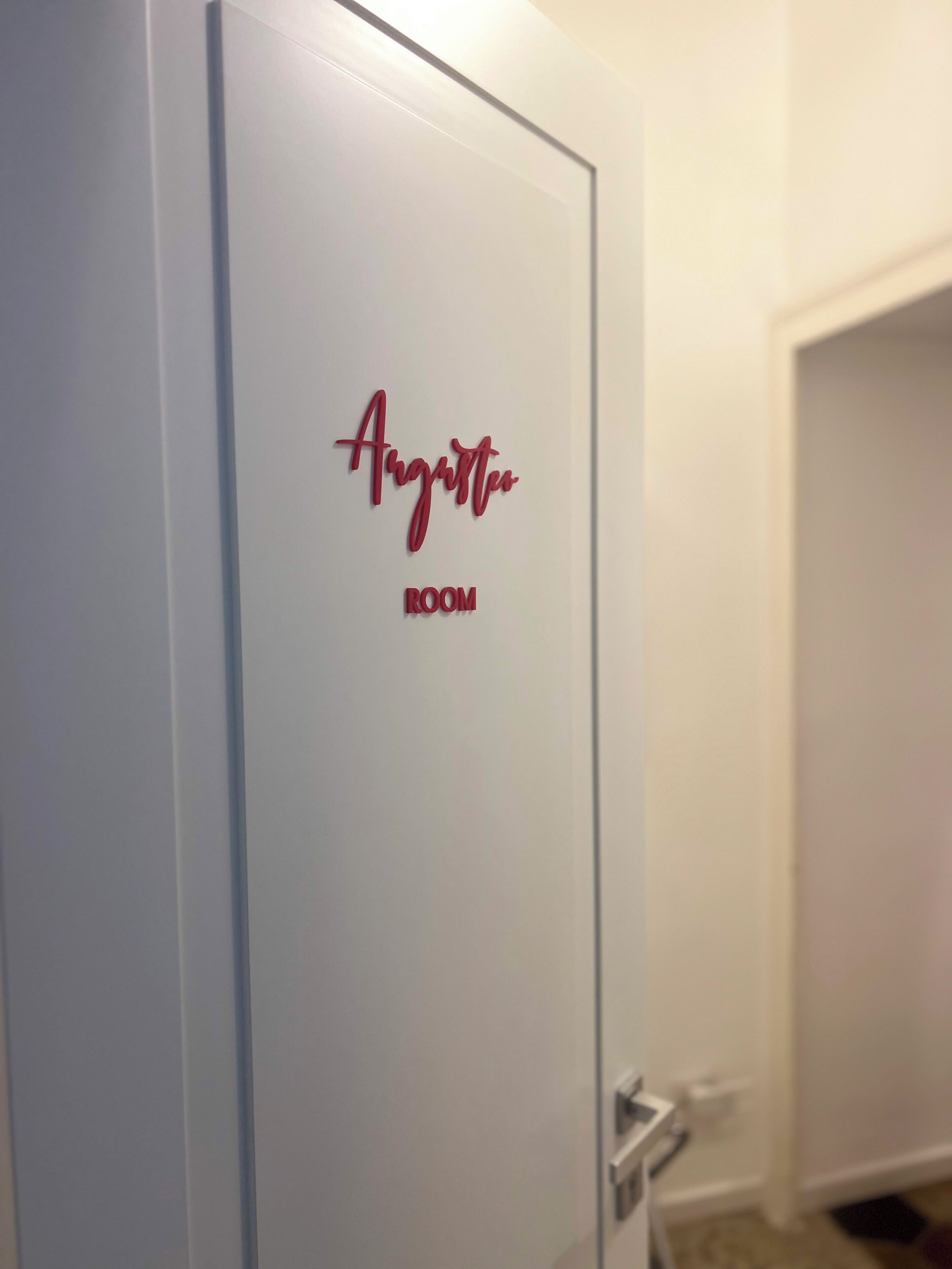A door with a sign that reads "Argento ROOM."