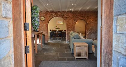 A spacious, dog friendly, country cottage with riverside walks and a pub nearby.