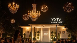 An outdoor dining area at the YYIV CLUBHOUSE with chandeliers, tables set for a formal event, and guests in attendance. - Taj Royal Farm (Noida)