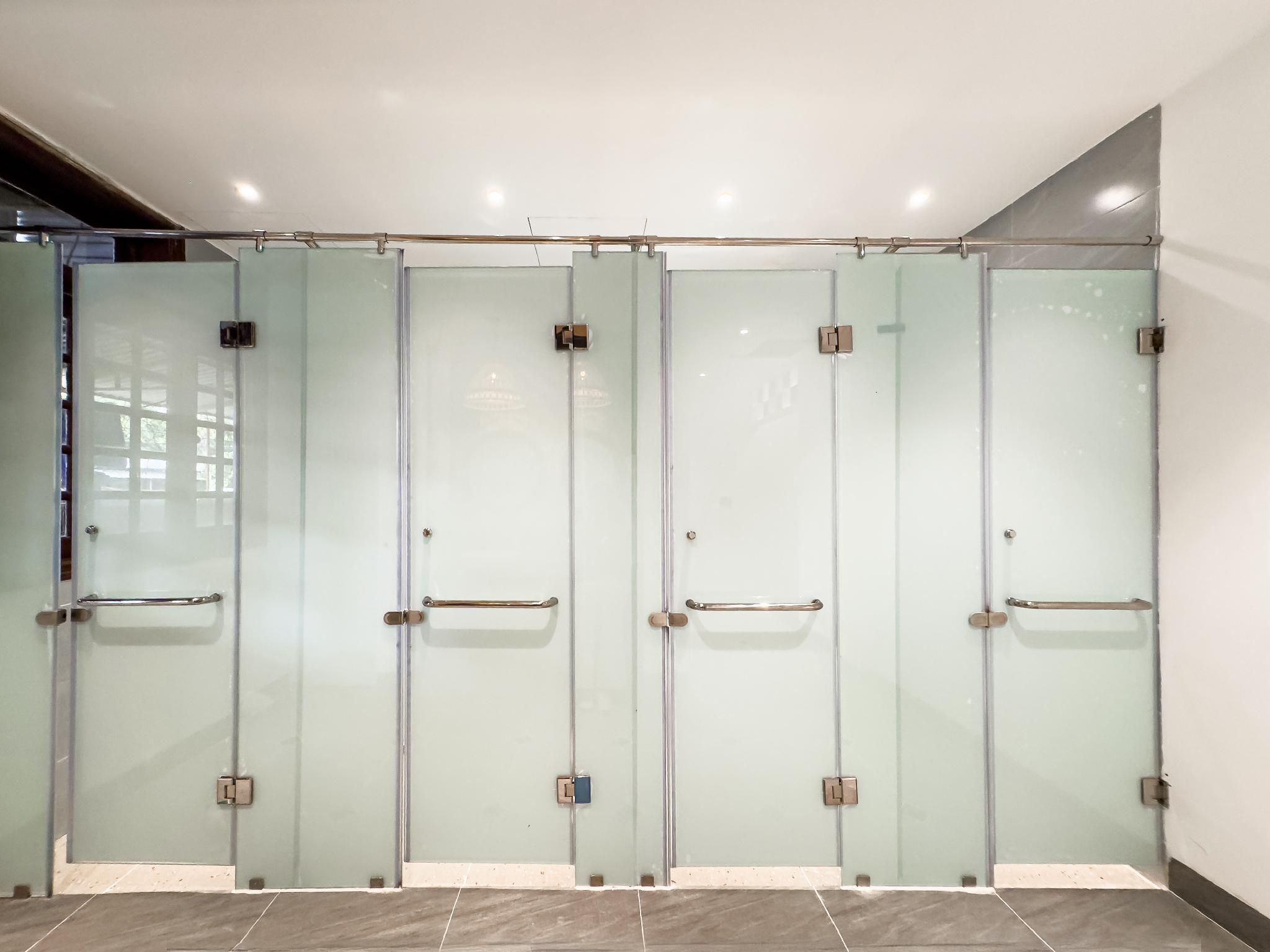 A row of four glass doors with metal handles, likely leading to private rooms or offices.