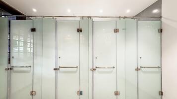 A row of four glass doors with metal handles, likely leading to private rooms or offices.