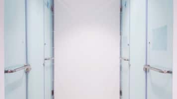 Shower, rainfall showerhead, hair dryer, towels