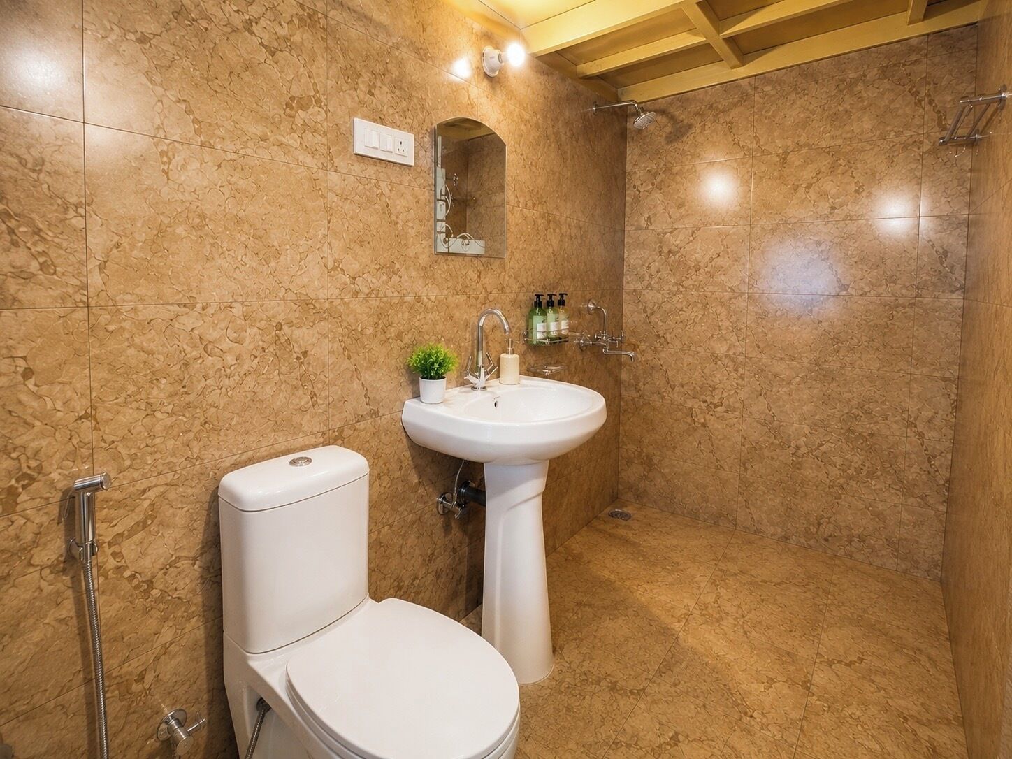 A bathroom with a toilet, sink, and shower.