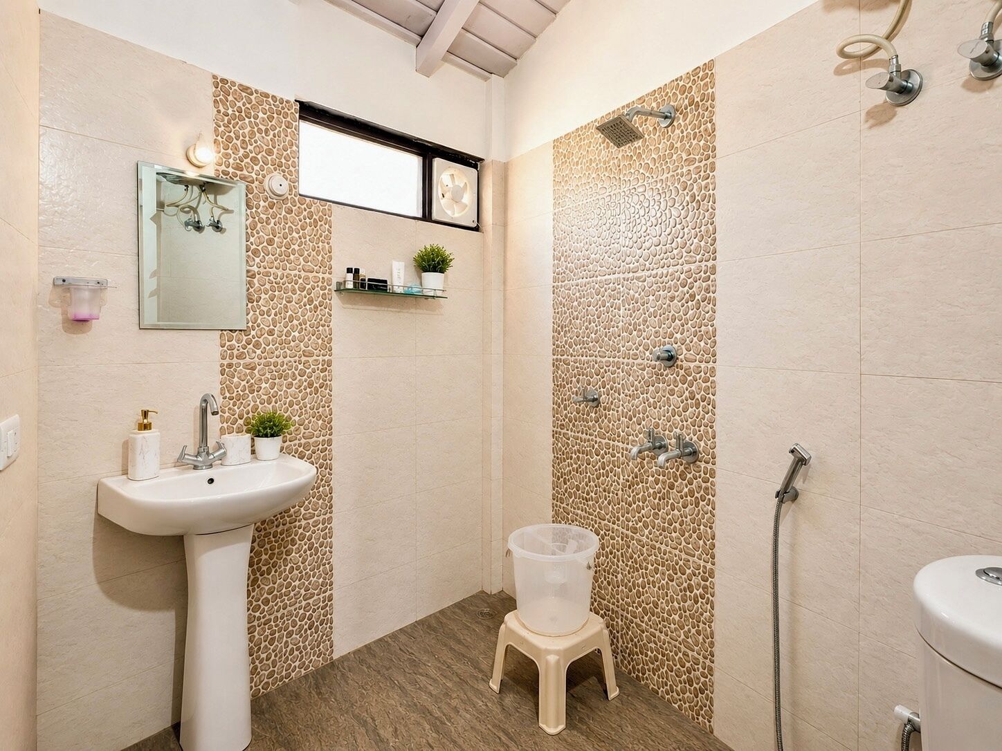 A bathroom with a sink, mirror, shower, and toilet.