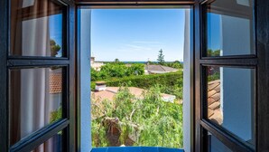 A view from a window with a clear sky, greenery, and distant buildings. - Villa Verde, a magnificent 210 m² villa (Les Tres Cales)