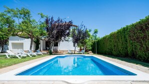 A swimming pool with lounge chairs and a stone patio. - Villa Verde, a magnificent 210 m² villa (Les Tres Cales)