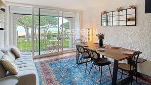 A dining area with a wooden table, chairs, and a blue patterned rug.
