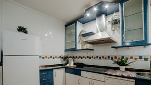 A kitchen with white cabinets, blue countertops, and a built-in dishwasher. - Comfortable Apartment with Terrace in Logroño (Logroño)
