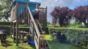 A wooden playhouse with a blue roof and a wooden ladder. - Mobile Home ADA 28m², 4 pers, Terrace (Marcilly-sur-Vienne)