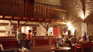 A rustic bar area with stone walls, wooden beams, and a pool table. - Mobile Home with Terrace for 6 persons (Sainte-Reine-de-Bretagne)