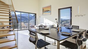A modern dining area with a panoramic mountain view, a staircase, and a large window. - Apartment 5 Guests Banyuls-sur-Mer with Parking and Air Conditioning (Banyuls-sur-Mer)