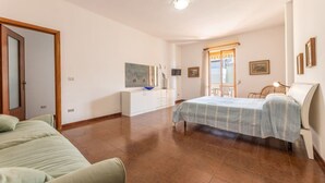 A bedroom with a bed, a dresser, a desk, and a chair. - Nice apartment for 8 guests with TV and balcony, close to Gallipoli (Baia Verde)