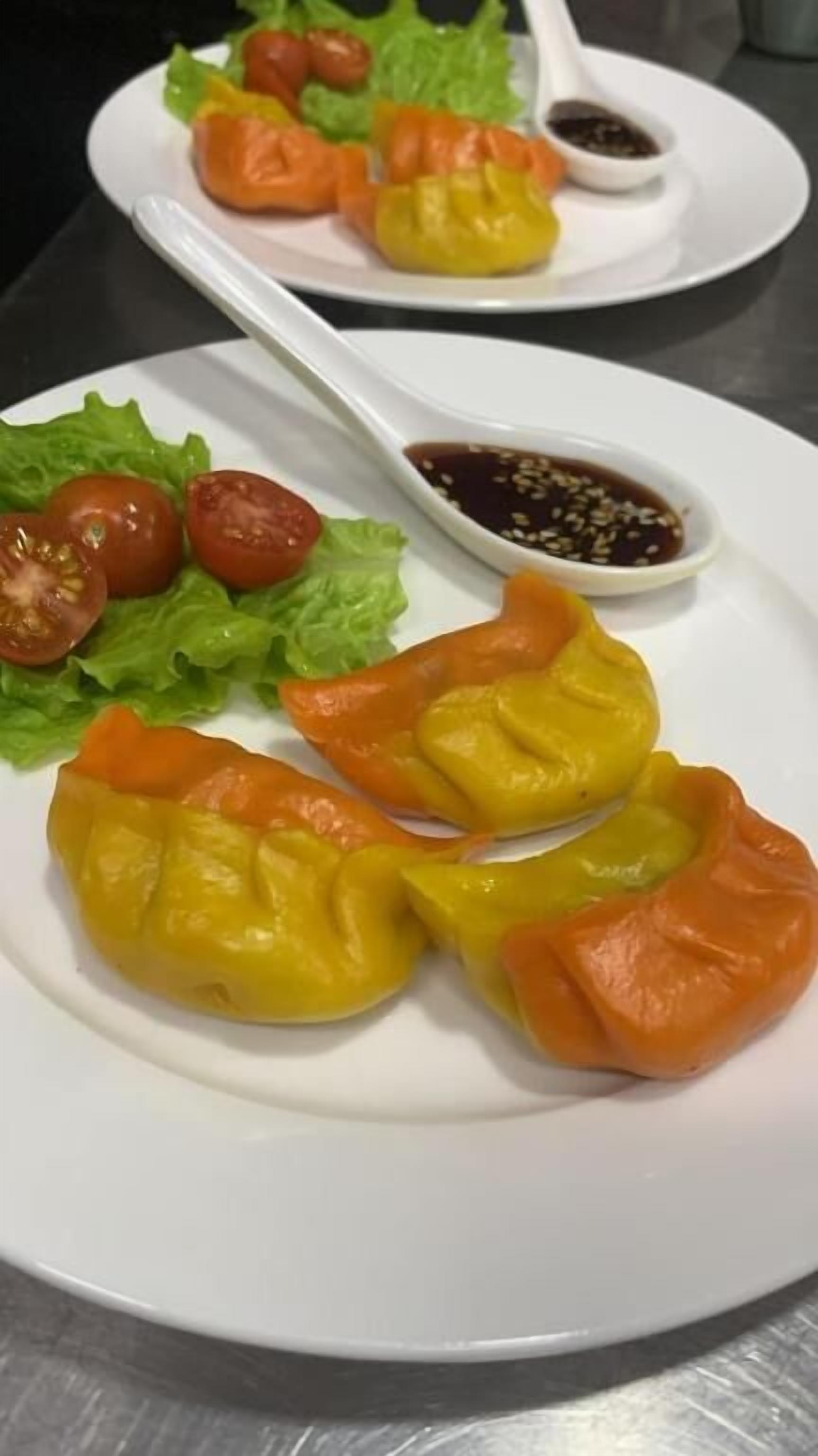 A plate of food with lettuce, cherry tomatoes, and a dipping sauce.