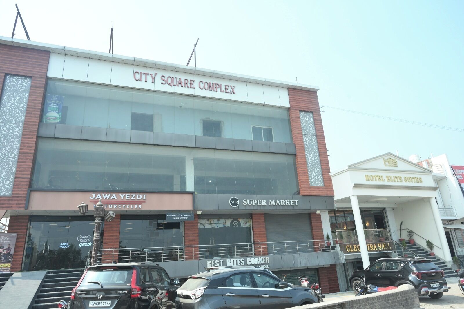 A multi-story building with a sign reading "City Square Complex."